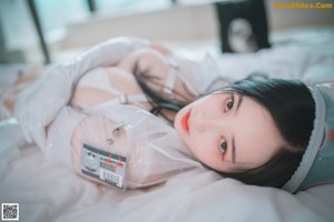 A woman in a nurse outfit is sitting on a couch.