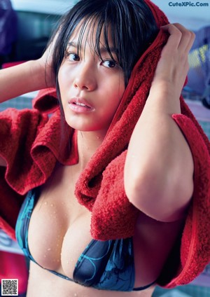A woman in a red bikini posing for a picture.