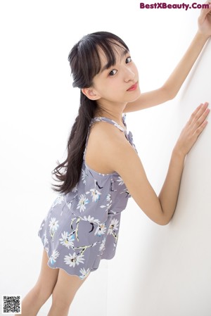 a woman standing in front of a white background