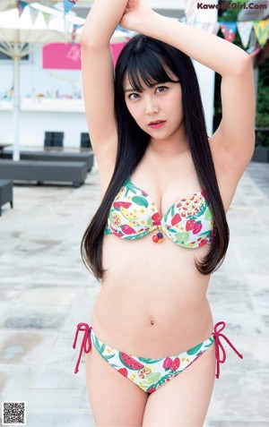 A woman in a black bathing suit posing for a picture.