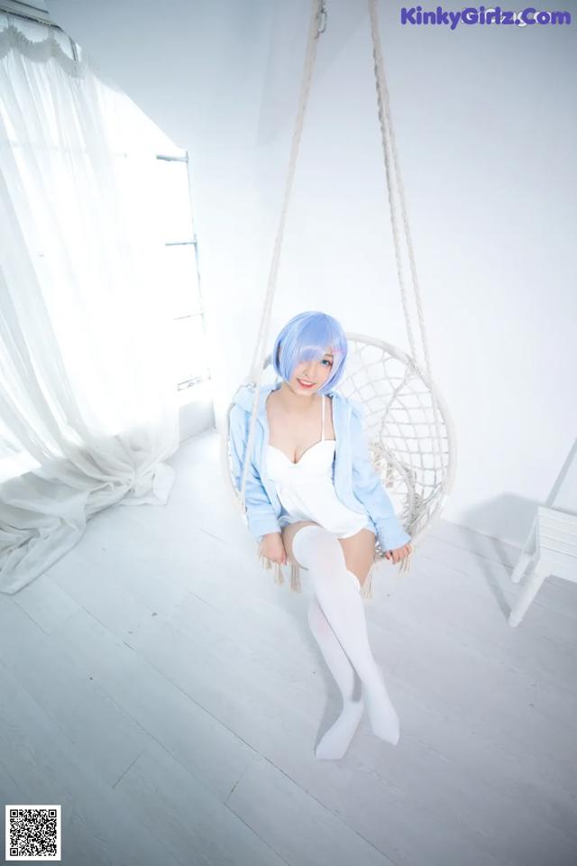 A woman sitting on a swing in a room.