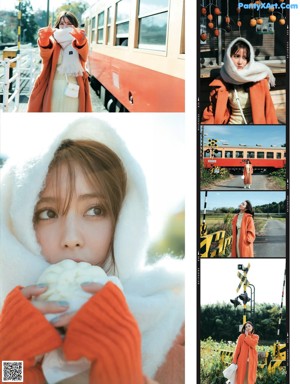 A woman in a red coat standing on a train track.