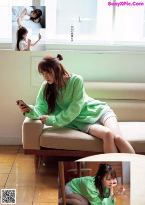 A woman sitting on top of a bed next to a window.
