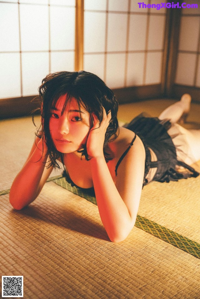 A woman laying on the floor in a room.