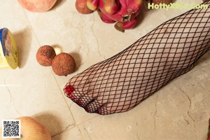 A woman sitting on a couch eating an apple.