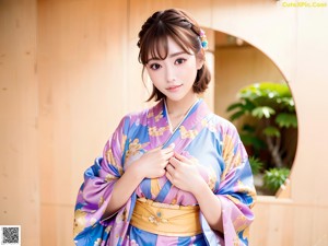 A woman in a purple kimono posing for a picture.
