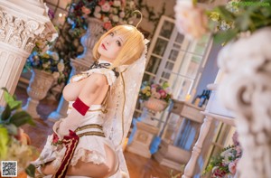 A woman in a white dress holding a sword.