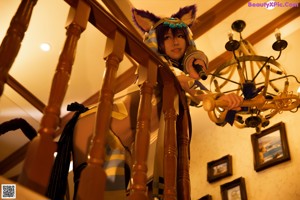 A woman dressed as an egyptian goddess holding a sword.