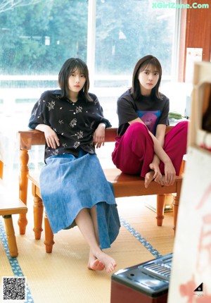 A couple of young women sitting next to each other.