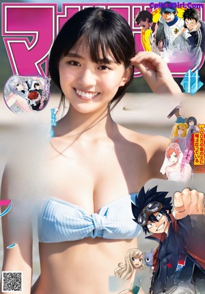 A woman in a blue bikini laying on the beach.