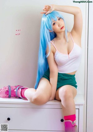 A collage of four pictures of a woman with blue hair.