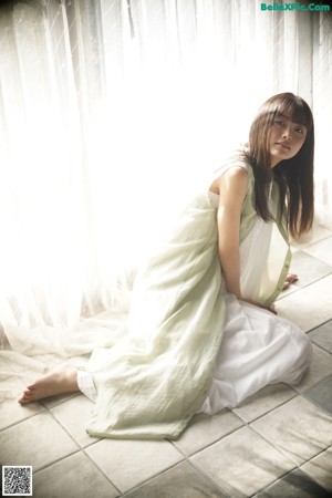 A woman laying on the floor looking at the camera.